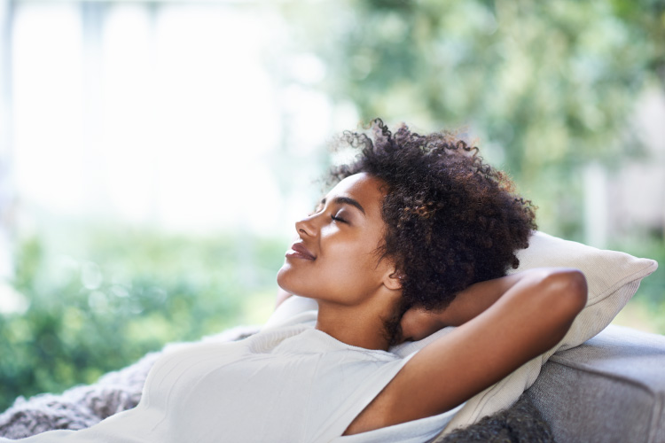 Curly-haired women reclines and relaxes without dental anxiety